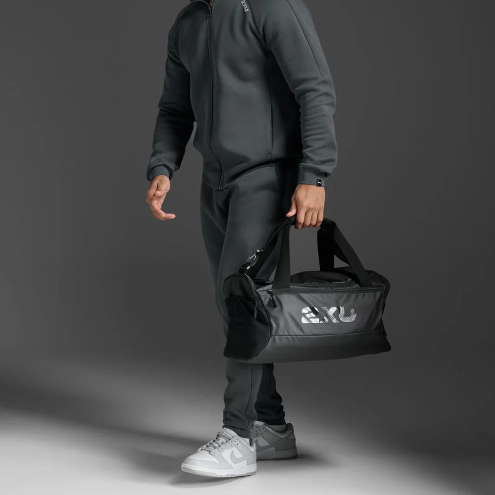 en mand holder en 2XU Gym Bag træningstasken (unisex)