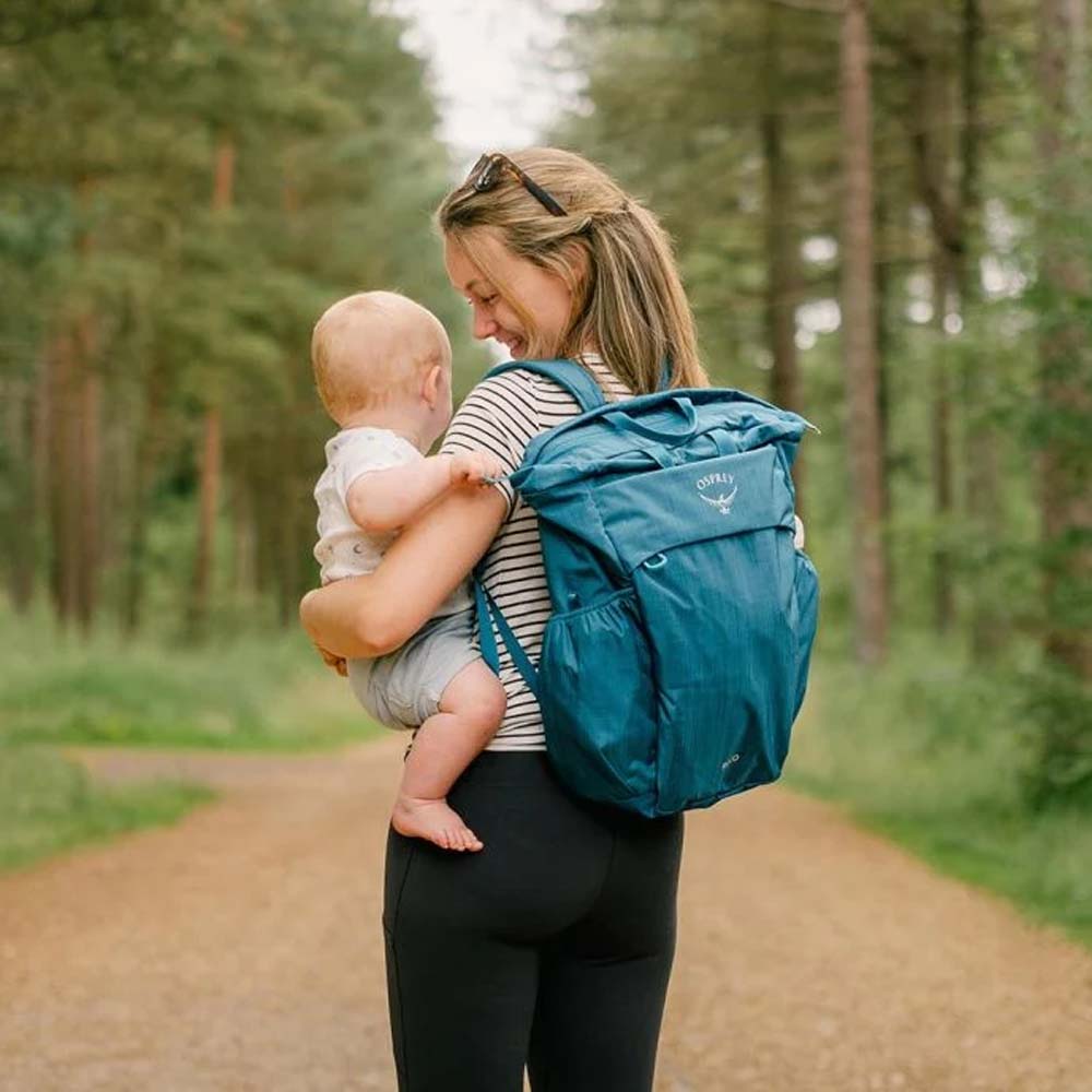 en kvinde bærer Osprey Poco™ Changing Tote skiftetaske (unisex)